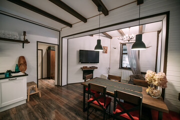 Combined kitchen and living room in a wooden Scandinavian country house.
