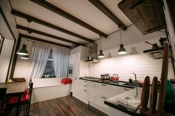Combined kitchen and living room in a wooden Scandinavian country house.