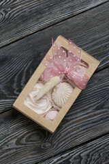 Homemade marshmallows in craft packaging. Zephyr in the form of a rose. Decorated with ribbon and lagurus. Close-up shot.