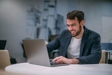 Portrait of contemporary young businessman at a working laptop