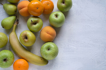 Assorted fruits on textured white