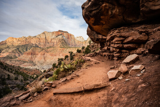 Watchmen Trail Snakes Around Rocky Cliff and Prickly Pear Cactus
