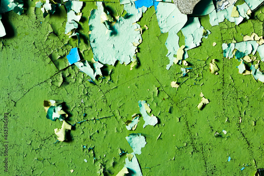 Poster wall with green paint in cracks. background for design. grunge texture