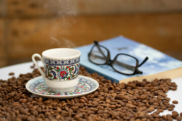 a cup of turkish coffee among the coffee grains