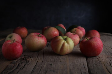 juicy apples lying on a rustic wooden table