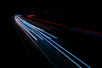Night road lights. Lights of moving cars at night. long exposure red, blue, green

