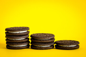 chocolate chip cookies on yellow background stacked