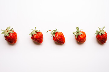 pattern of real honest farm organic berry strawberries isolated on a white background. seasonal summer food top view, flat lay