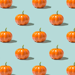 Happy Halloween concept. Photo of orange  pumpkin with shadow pattern isolated over light color blue backdrop