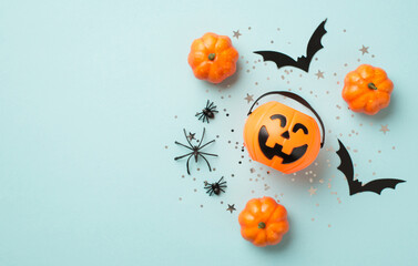 Top view photo of halloween decorations pumpkin basket silver sequins stars spiders and bat...