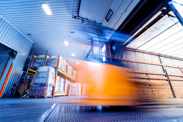Forklift loader working at beverages plant warehouse