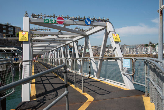 Plymouth, Devon, England, UK. 2021.  Pedestrian two way metal linkspan bridge between the shore and a boat jetty