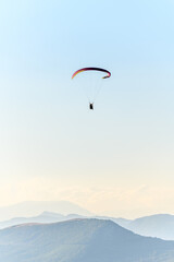 Fototapeta na wymiar Paragliding flight in the air over the mountains.