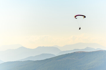 Paragliding flight in the air over the mountains.