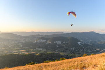 Paragliding flight in the air over the mountains.
