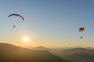 Paragliding flight in the air over the mountains.
