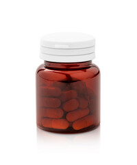 brown plastic bottle with supplement or vitamin capsules isolated on white background