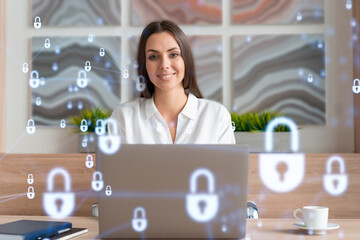 Attractive businesswoman in white shirt at workplace working with laptop to defend customer cyber...