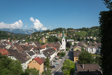 Fototapeta na wymiar Cityscape of Feldkirch from the heights of the 12th century medieval Schattenburg castle on a summer day with blue sky, Vorarlberg, Austria, Europe.