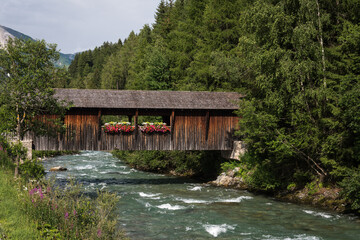 Wooden bridge crossing over Rosanna river, ski resort, St. Anton am Alberg, Vorarlberg, Austria