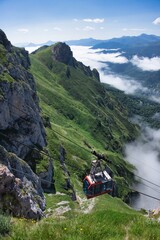 Fototapeta na wymiar A overhead cable car lift up the mountain