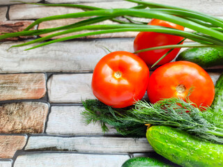 Vegetable summer composition. Tomatoes, cucumbers, green onions, parsley, herbs.
