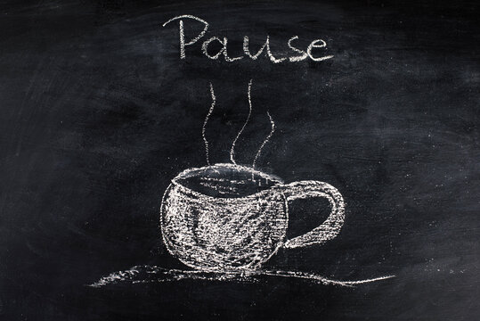 Chalk drawing of a cup of coffee on a blackboard, taking a break