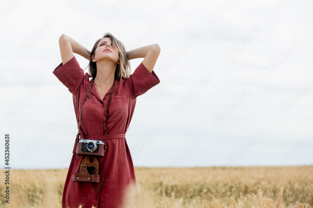 Sticker young woman in red dress with camera on wheat field