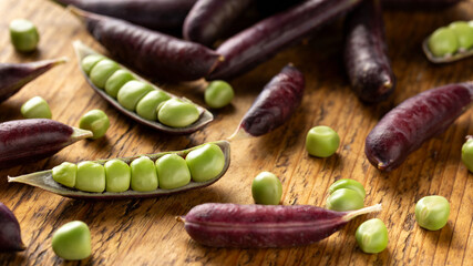Sweet purple Magnolia Pea, Sugarsnap on rustic wooden board. ready to eat