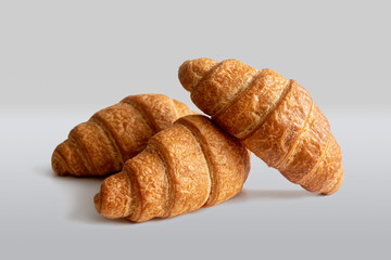 Fresh croissants made of puff pastry on a light background