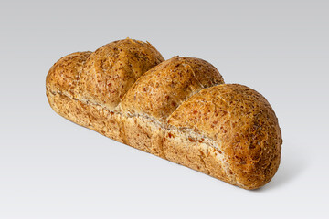 Loaf of bread made of wheat and oat flour on a light background