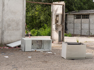 Dilapidated Little Houses Among the Trees and Vegetation and Dump of Old Appliances