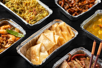 Chinese takeaway food. Kung Po king prawns, crispy won ton, roast pork char siu, prawn curry,...