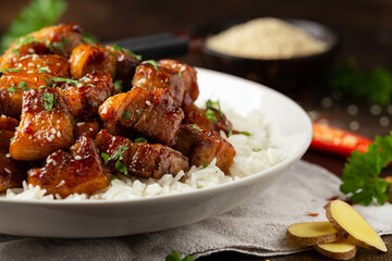 Chinese traditional cuisine sticky braised pork belly with rice on white plate