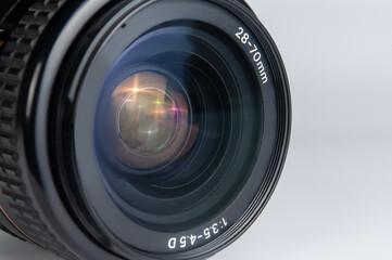 close-up of DSLR camera lens on white background