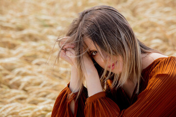 young woman have a rest on wheat field