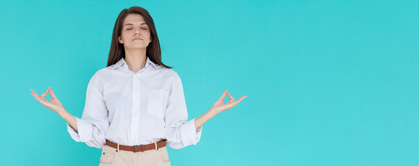 Beauiful young female makes mudra sign, relaxes after hard working day, keeps eyes shut, practises...