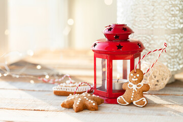 Home handmade decor with traditional christmas gingerbread cookies, cinnamon stick and red candle...