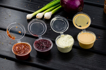 Assorted different sauces in plastic. ketchup, mustard, sour cream for dishes for delivery.