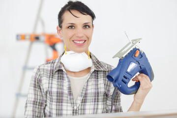 woman working with a angle grinder at home