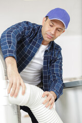 man is dealing with pipes