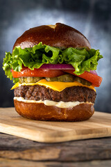 Cheeseburger with Pretzel Roll on a wooden board