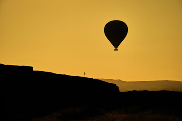 Silhouette of hot air balloon in Cappadocia Urgup with yellow and black colors