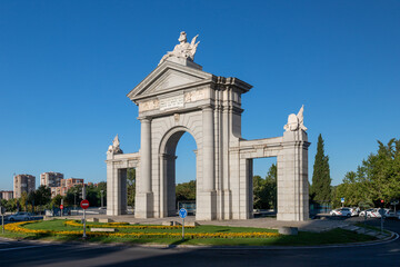 Fototapeta na wymiar Puerta de Segovia, a Neo-classical monument in Madrid, it is one of the modern post-Roman triumphal arch built in Europe and similar to the monuments Arc de Triomphe in Paris