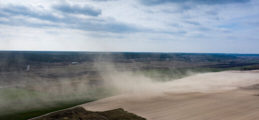 Dust storm on an agricultural field. Drone view