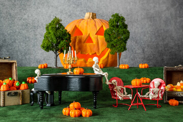 skeletons having Halloween party with piano pumpkins candy corn and jack o lantern