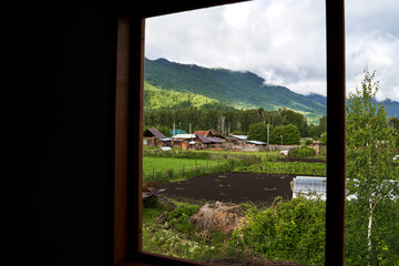 Holistay house. Countryside hiking. Window view. Vacation landscape. Russian Altai mountains. Staycation concept. Reduce carbon footprint. Sustainable lifestyle. Holiday trail. Local travel