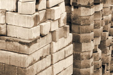 Pile of red bricks is construction materials.