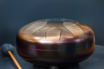 Steel tongue, drum. Singing bowl, steel drum and drumsticks. Instrument for sound wave therapy and...