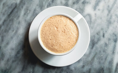 Fototapeta premium full cup of cappuccino or coffee close up on grey marble stone background